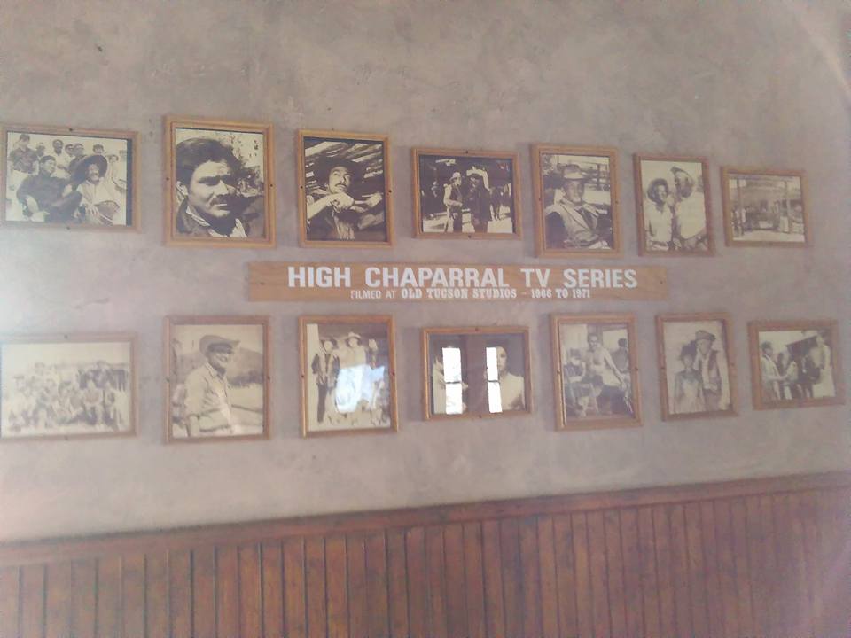 Framed photos and a sign reading "High Chaparral TV Series, filmed at Old Tucson Studios, 1966 to 1971" are displayed on one wall.