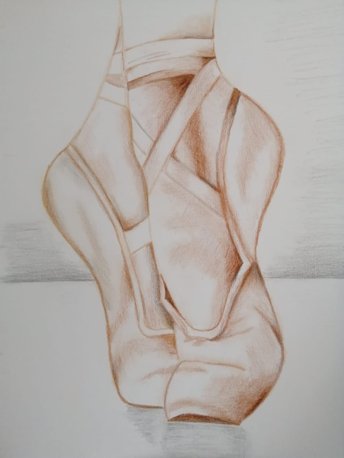 A drawing of ballet pointe shoes, like a dancer's dreaming heart, rests elegantly on a flat surface, depicted in shades of brown and beige. They capture the essence of a shining star in the world of dance.